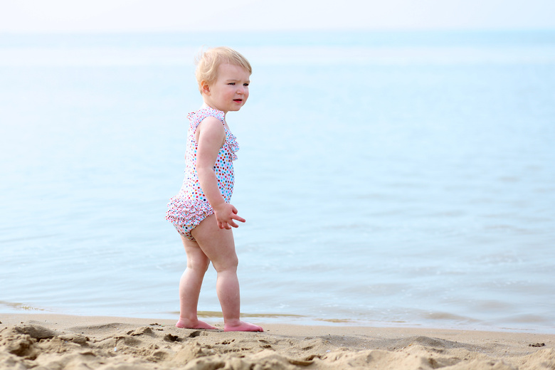 Cute toddler playing on the beach